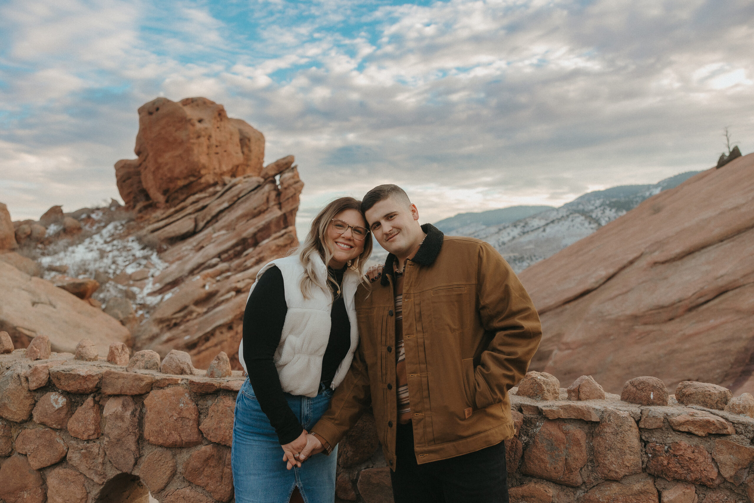 Red Rocks Amphitheater Colorado Couple posing for engagement photos